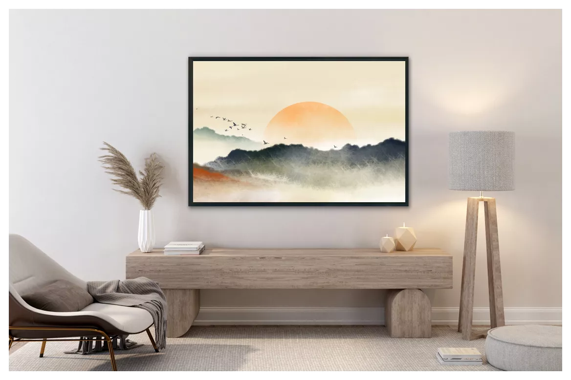 Paysage à l’aquarelle, soleil orange au-dessus de montagnes gris-bleu, en caisse américaine noire au-dessus d’un banc en bois clair